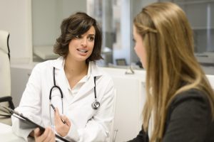 Female doctor explaining diagnosis to her female patient